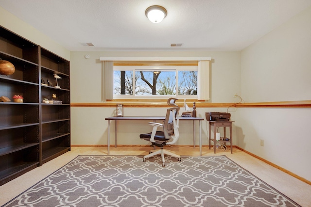 office with baseboards and visible vents