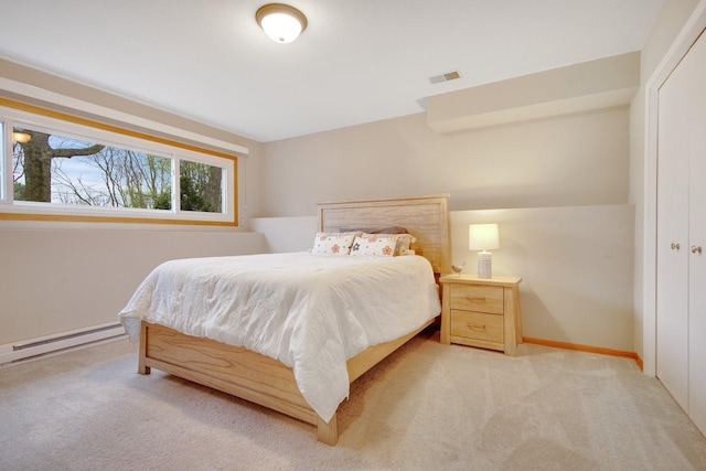 carpeted bedroom with baseboards, baseboard heating, and visible vents