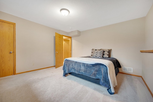 carpeted bedroom with baseboards and visible vents