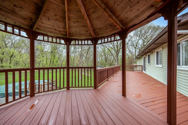wooden terrace featuring a lawn