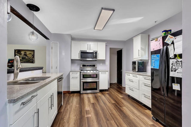 2021 6th St SW, Willmar, MN 56201 - kitchen with stainless steel appliances, a sink, and white cabinetry