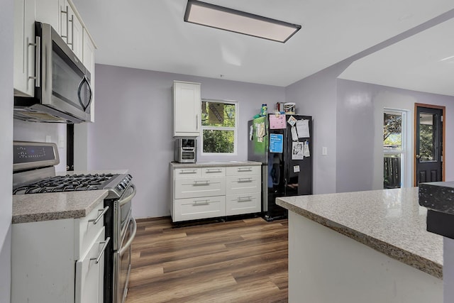 2021 6th St SW, Willmar, MN 56201 - kitchen featuring stainless steel appliances, dark wood finished floors, white cabinetry, and light countertops