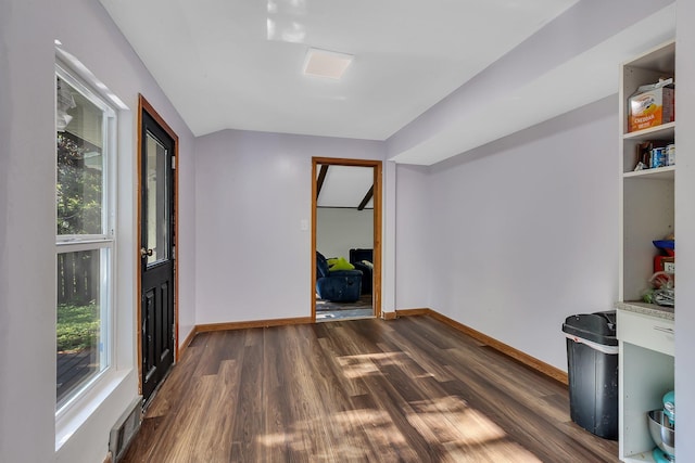 2021 6th St SW, Willmar, MN 56201 - spare room featuring healthy amount of natural light, dark wood finished floors, and baseboards