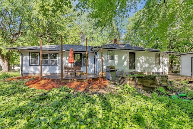 2021 6th St SW, Willmar, MN 56201 - view of front of home with a deck, a chimney, and a patio