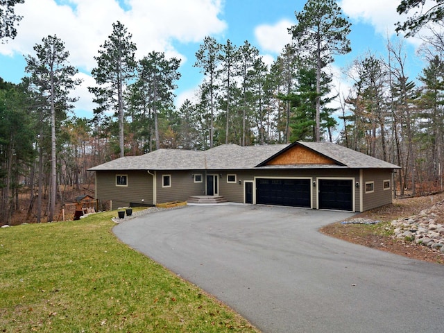 ranch-style house with a front lawn, driveway, and an attached garage