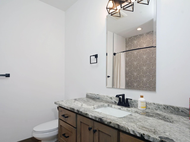 bathroom with toilet, curtained shower, and vanity