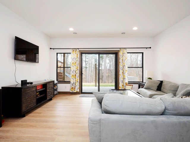 living area featuring plenty of natural light, light wood finished floors, and recessed lighting