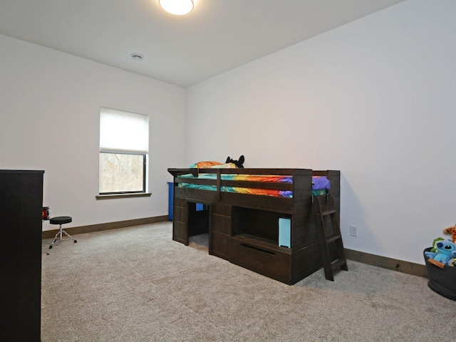 bedroom featuring carpet flooring and baseboards