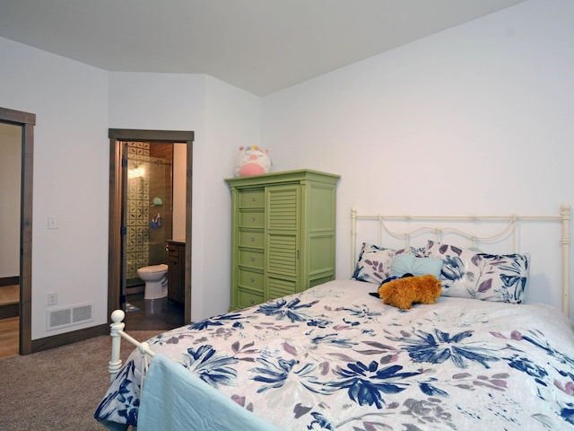 bedroom featuring visible vents, ensuite bath, and carpet flooring