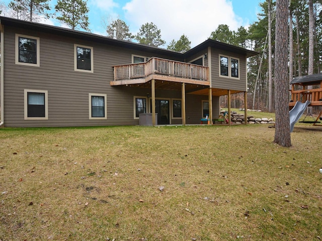 back of property with a deck and a yard