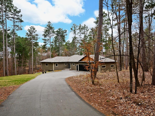 view of front of house featuring aphalt driveway and a garage