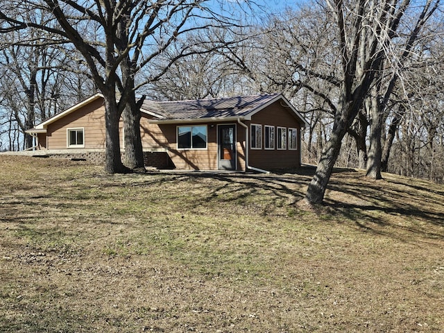 view of front of property with a front lawn and metal roof