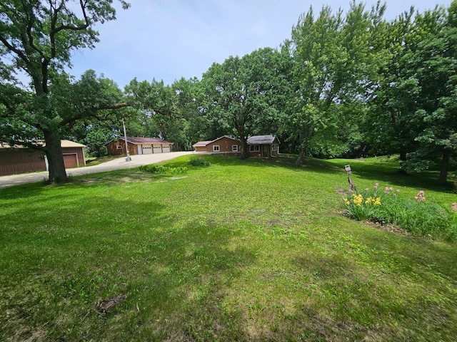 6788 39th Ave NW, Garfield, MN 56332 - view of green lawn featuring a garage and an outbuilding