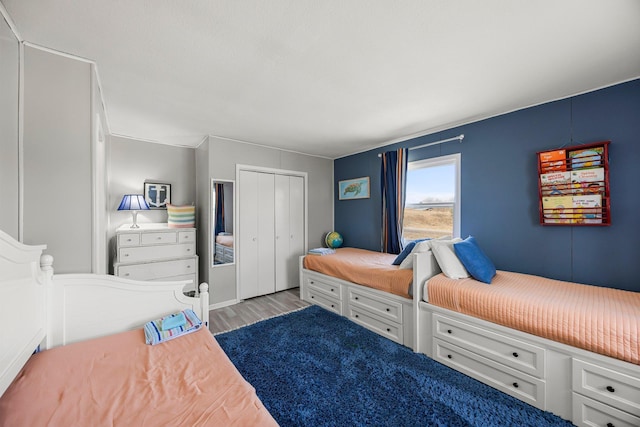 bedroom with a closet and light wood-style flooring