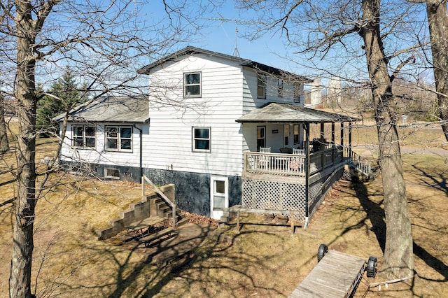 rear view of house featuring central AC