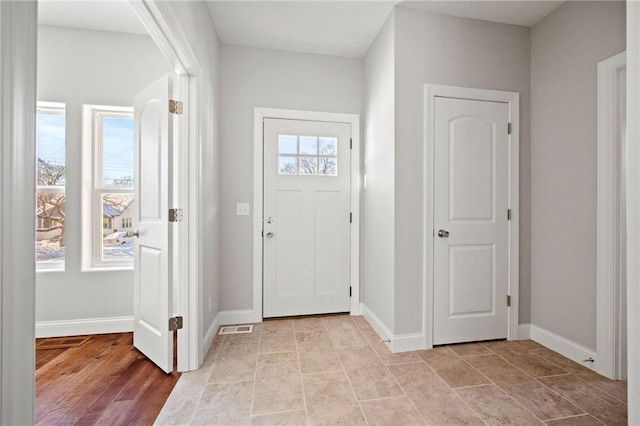 entryway with visible vents and baseboards