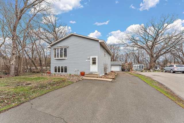1786 English St, Maplewood, MN 55109 - view of home's exterior featuring a detached garage