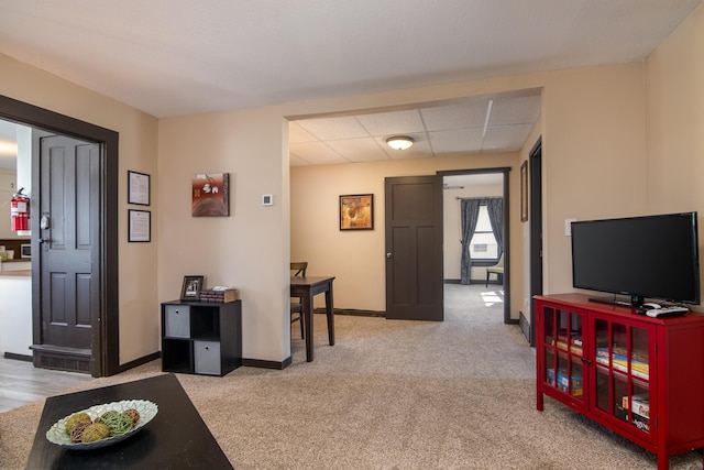 314 High St, Lake City, MN 55041 - living area with light carpet, a paneled ceiling, and baseboards
