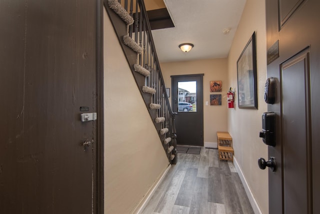 314 High St, Lake City, MN 55041 - doorway with baseboards, wood finished floors, and stairs
