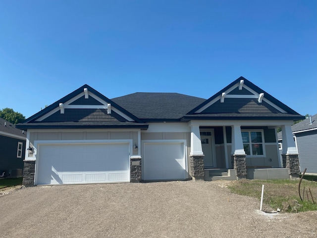 10518 28th St NE, Saint Michael, MN 55376 - craftsman-style home with stone siding, driveway, an attached garage, and covered porch