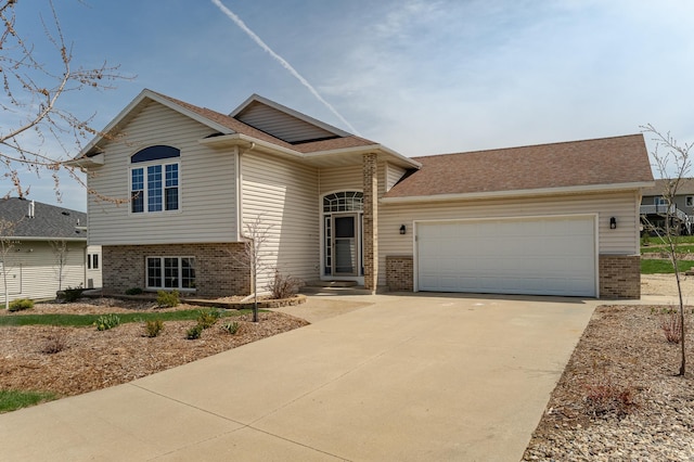 506 6th Pl NE, Byron, MN 55920 - view of front of property featuring brick siding, a shingled roof, an attached garage, and concrete driveway