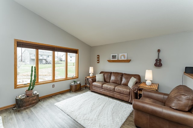 506 6th Pl NE, Byron, MN 55920 - living room featuring baseboards, vaulted ceiling, visible vents, and light wood-style floors