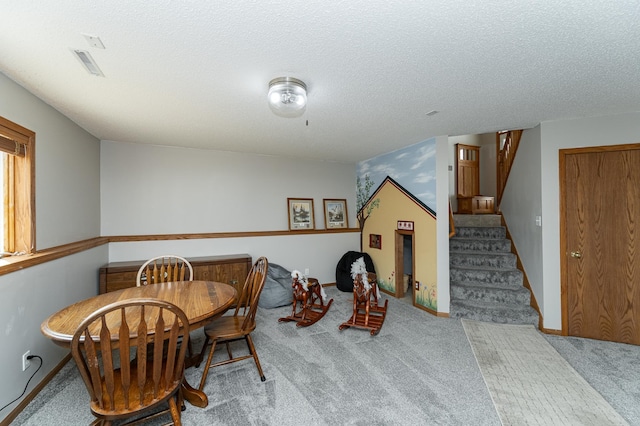 506 6th Pl NE, Byron, MN 55920 - carpeted dining area with baseboards, a textured ceiling, and stairs
