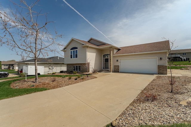 506 6th Pl NE, Byron, MN 55920 - view of front of house with concrete driveway, brick siding, and an attached garage