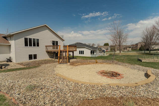 506 6th Pl NE, Byron, MN 55920 - rear view of house with a fire pit, a wooden deck, stairway, and fence