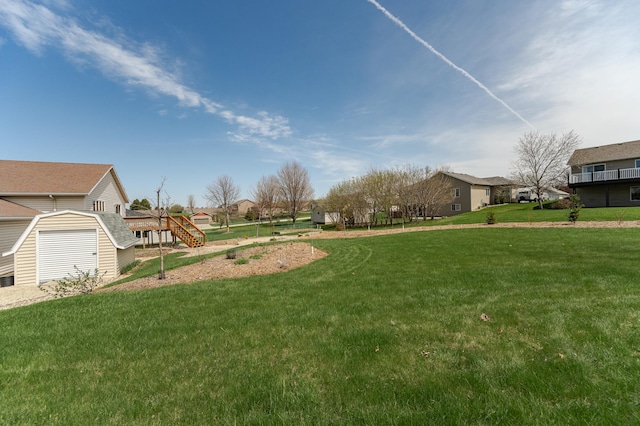 506 6th Pl NE, Byron, MN 55920 - view of yard featuring a storage shed, a residential view, a wooden deck, stairway, and an outdoor structure