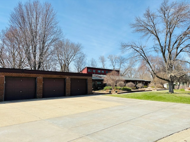 1826 Coolidge Ct, Northfield, MN 55057 - view of front of home featuring driveway, a front lawn, and brick siding