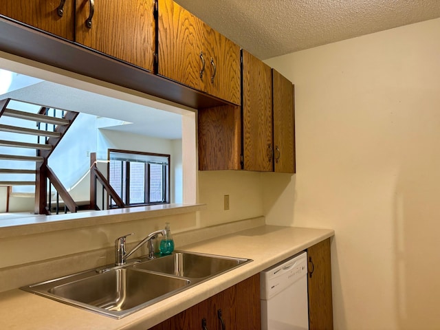 1826 Coolidge Ct, Northfield, MN 55057 - kitchen with brown cabinetry, dishwasher, light countertops, and a sink
