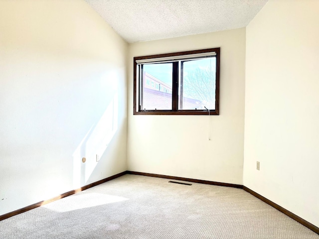 1826 Coolidge Ct, Northfield, MN 55057 - empty room with visible vents, baseboards, a textured ceiling, and light colored carpet