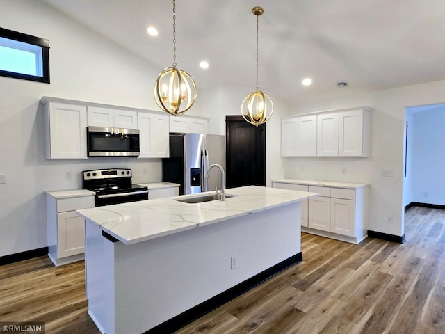 kitchen featuring an inviting chandelier, appliances with stainless steel finishes, a sink, and baseboards