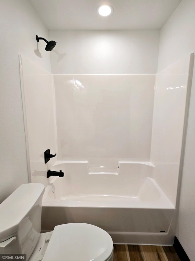full bath featuring toilet, shower / bathtub combination, wood finished floors, and recessed lighting