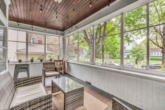 sunroom featuring an outdoor hangout area and rail lighting