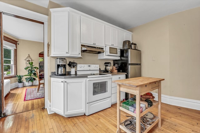 kitchen featuring white appliances, white cabinetry, under cabinet range hood, and light wood finished floors