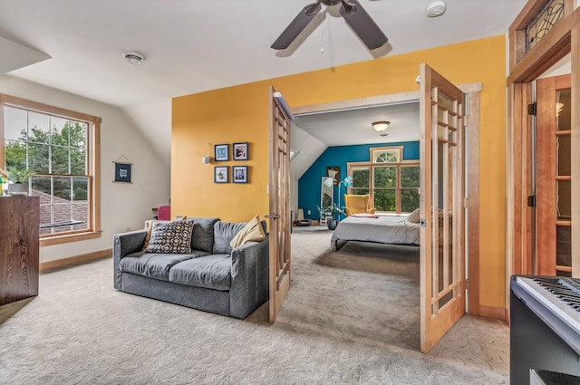 bedroom featuring a ceiling fan, baseboards, carpet, and vaulted ceiling