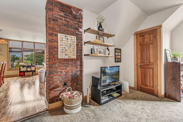 living area with baseboards and wood finished floors