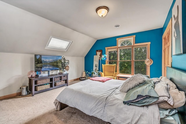 carpeted bedroom featuring baseboards and vaulted ceiling