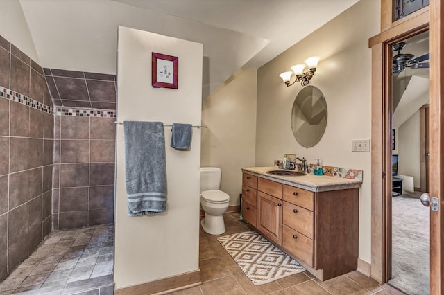 full bathroom featuring tile patterned flooring, a walk in shower, vanity, baseboards, and toilet