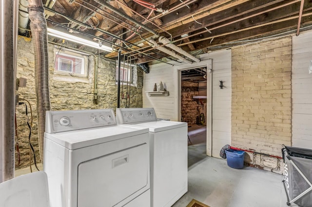 clothes washing area with washing machine and clothes dryer and laundry area