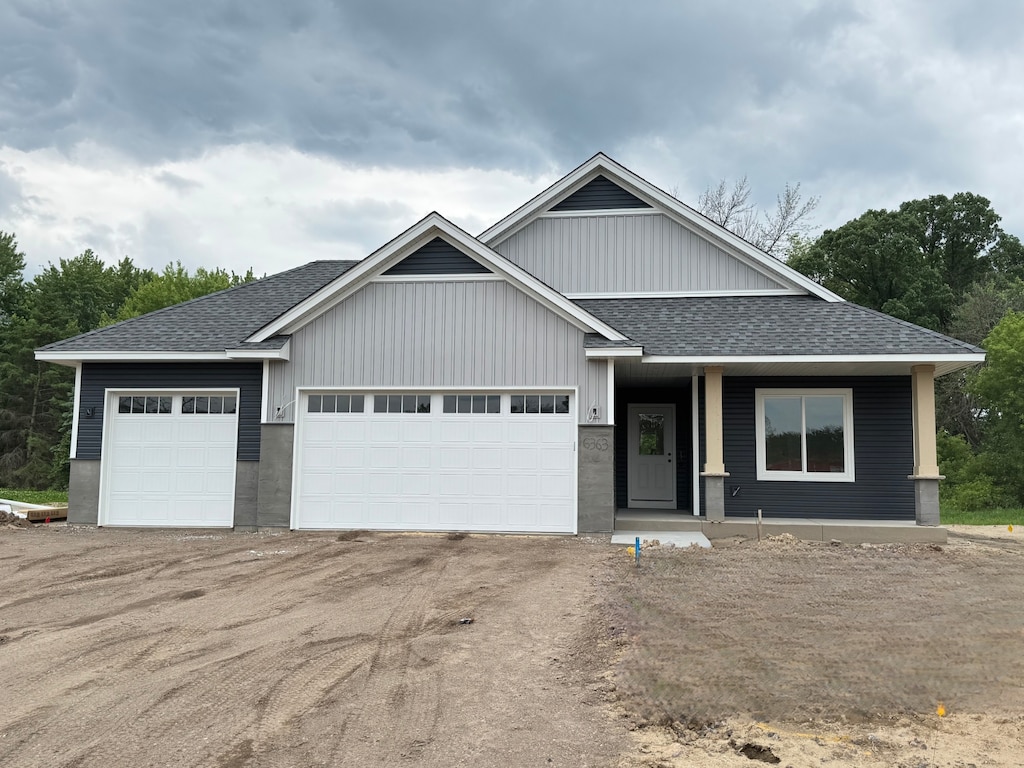 6363 Goodwin Ln, Wyoming, MN 55092 - view of front of home featuring roof with shingles, covered porch, an attached garage, and driveway