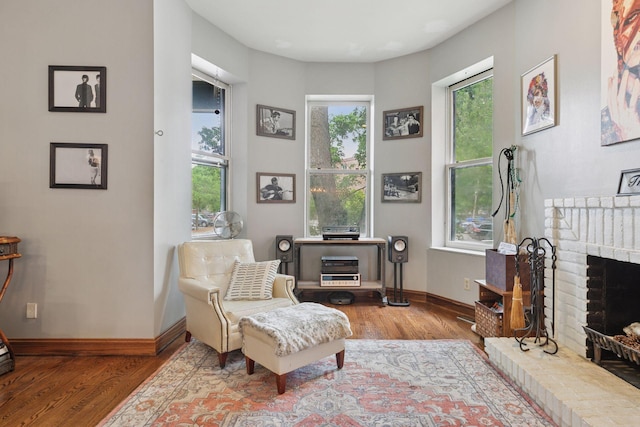 231 Arundel St Unit 1, Saint Paul, MN 55102 - sitting room with wood finished floors and a brick fireplace