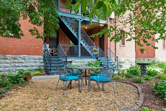 231 Arundel St Unit 1, Saint Paul, MN 55102 - view of patio / terrace with stairs, a deck, and outdoor dining area