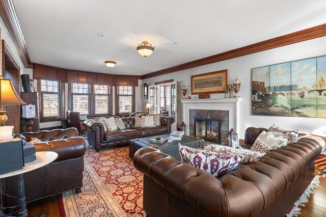 818 Summit Ave, Saint Paul, MN 55105 - living area featuring wood finished floors, crown molding, plenty of natural light, and a tile fireplace