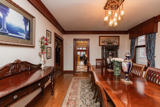 818 Summit Ave, Saint Paul, MN 55105 - dining area with a chandelier, ornamental molding, healthy amount of natural light, wood finished floors, and baseboards