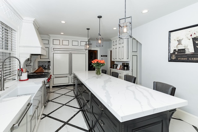 818 Summit Ave, Saint Paul, MN 55105 - kitchen with premium appliances, a kitchen island, backsplash, recessed lighting, and dark cabinetry