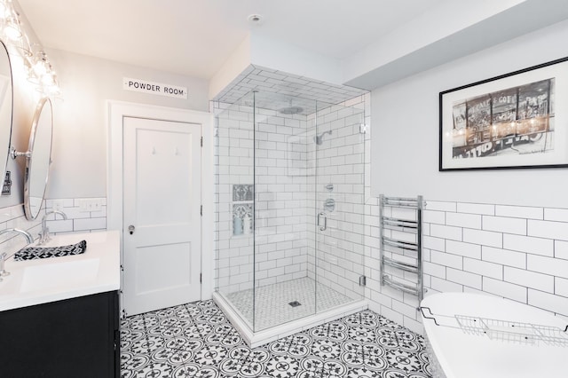 818 Summit Ave, Saint Paul, MN 55105 - full bathroom featuring tile walls, a shower stall, a freestanding bath, tile patterned flooring, and vanity