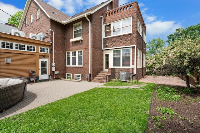 818 Summit Ave, Saint Paul, MN 55105 - back of house with central AC unit, brick siding, a yard, and a patio